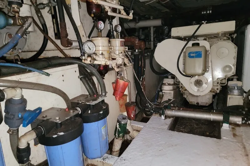 Slide: The Image of Engine room of 1989 Custom Rob Ladd PH Motorsailer Cutter, showcasing mechanical components and gauges. - 38