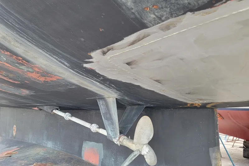 Slide: The Image of Underside view of 1989 Custom Rob Ladd PH Motorsailer Cutter, showing propeller and hull details. - 64