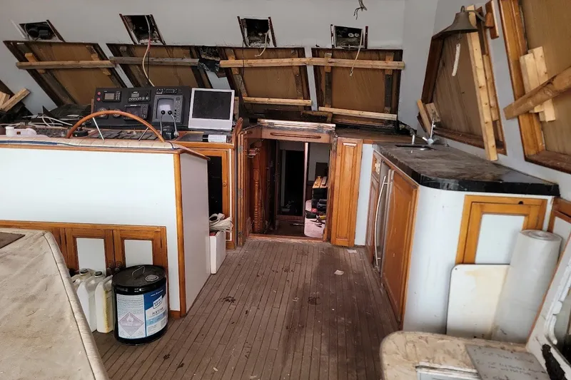 Slide: The Image of Interior of 1989 Custom Rob Ladd PH Motorsailer Cutter, showing navigation equipment and wooden cabinetry. - 55