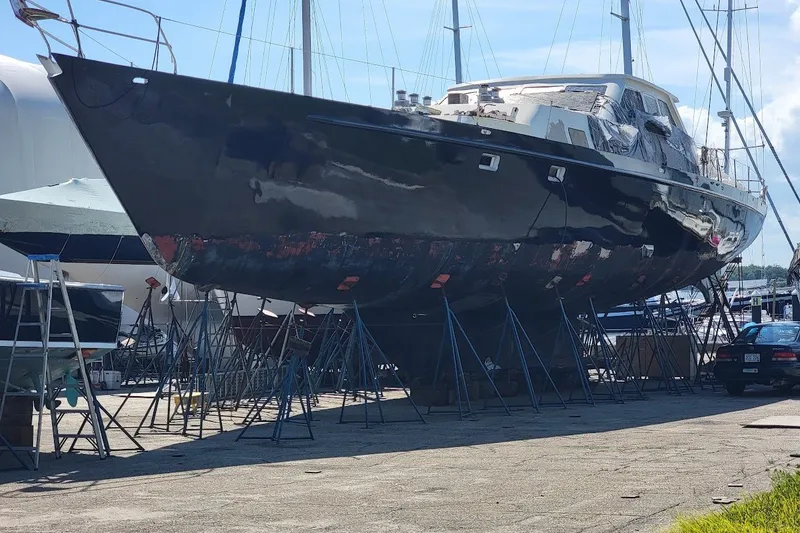 Slide: The Image of Custom Robb Ladd Pilothouse Cutter 98 PH Motorsailer, 1989, on stands in a boatyard. - 3