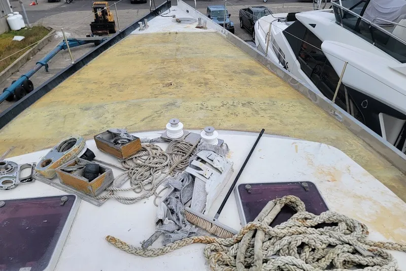 Slide: The Image of Deck of 1989 Custom Rob Ladd PH Motorsailer Cutter with ropes and equipment. - 50