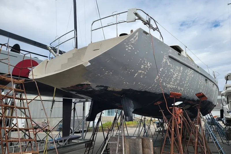 Slide: The Image of 1989 Custom Rob Ladd PH Motorsailer Cutter under restoration in a boatyard. - 74