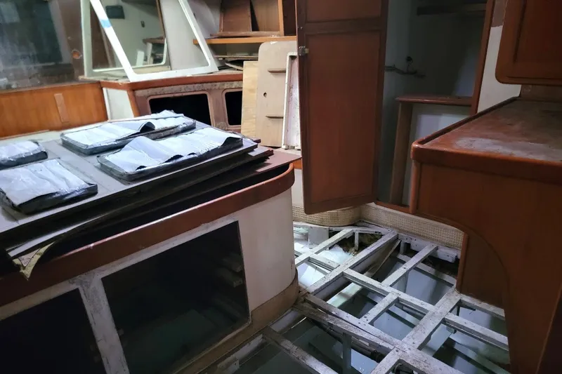 Slide: The Image of Interior of 1989 Custom Rob Ladd PH Motorsailer Cutter, showing unfinished cabin with exposed framework. - 42