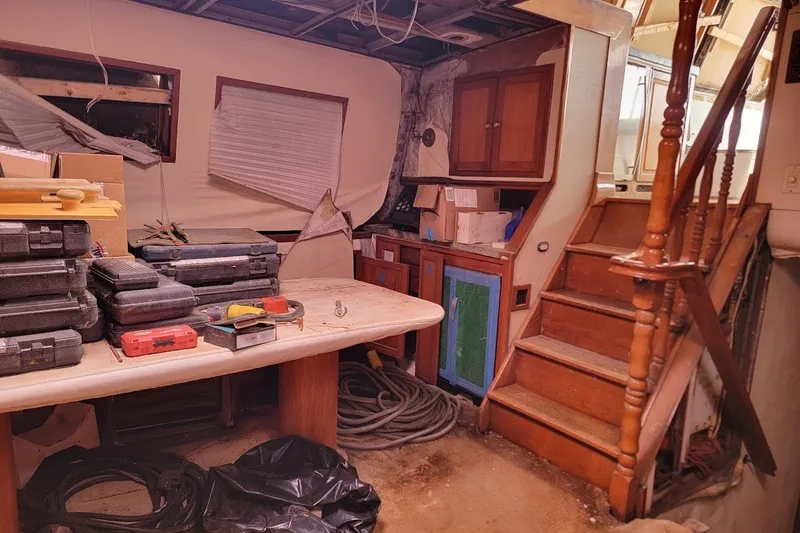 Slide: The Image of Interior of 1989 Custom Rob Ladd PH Motorsailer Cutter, showing tools and wooden stairs. - 36