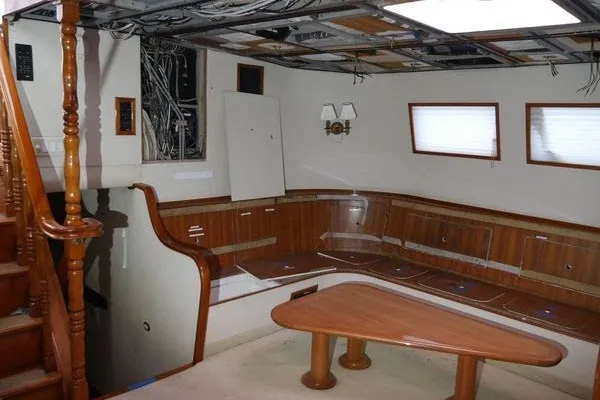 Slide: The Image of Interior of 1989 Custom Robb Ladd Pilothouse Cutter, featuring wood paneling and seating area. - 11