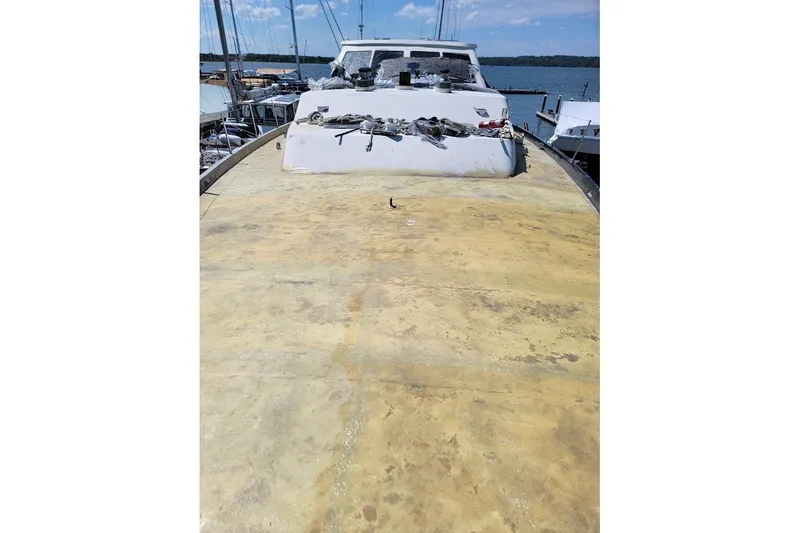 Slide: The Image of 1989 Custom Robb Ladd Pilothouse Cutter, 98 PH Motorsailer, docked, showing weathered deck. - 16