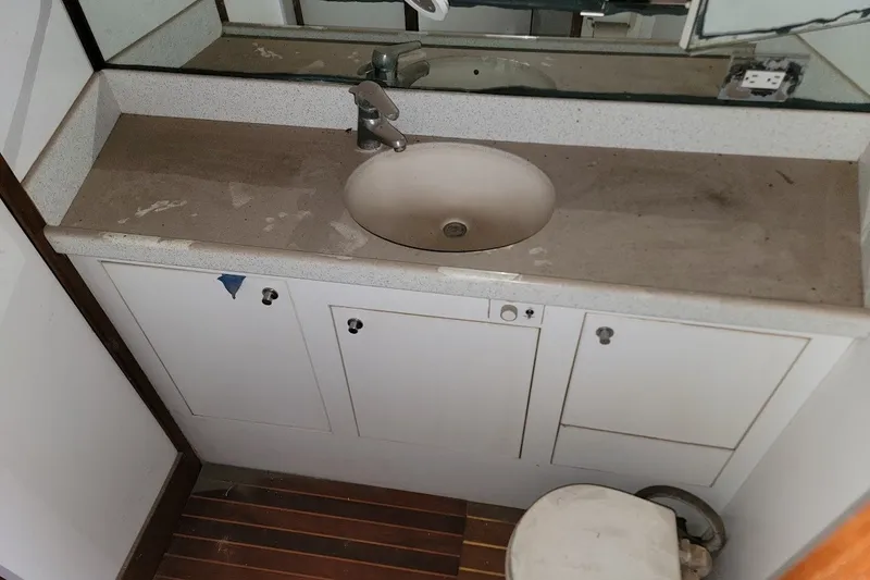 Slide: The Image of Bathroom sink and cabinet in 1989 Custom Rob Ladd PH Motorsailer Cutter. - 57