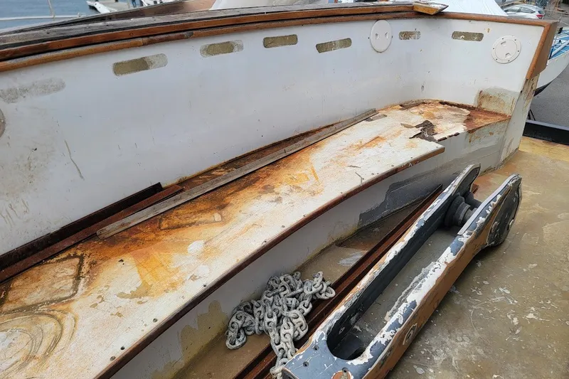 Slide: The Image of Weathered deck of 1989 Rob Ladd PH Motorsailer Cutter, showing rust and chain. - 33