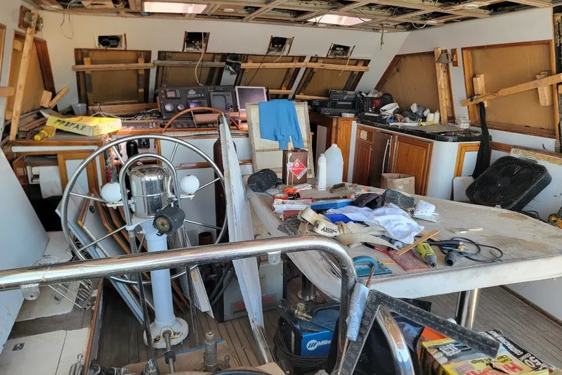 Slide: The Image of Interior of a 1989 Custom Robb Ladd Pilothouse Cutter under renovation, showcasing tools and equipment. - 6