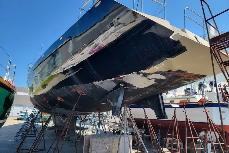 Slide: The Image of Custom Robb Ladd Pilothouse Cutter 98 PH Motorsailer, 1989, under maintenance in a shipyard. - 4