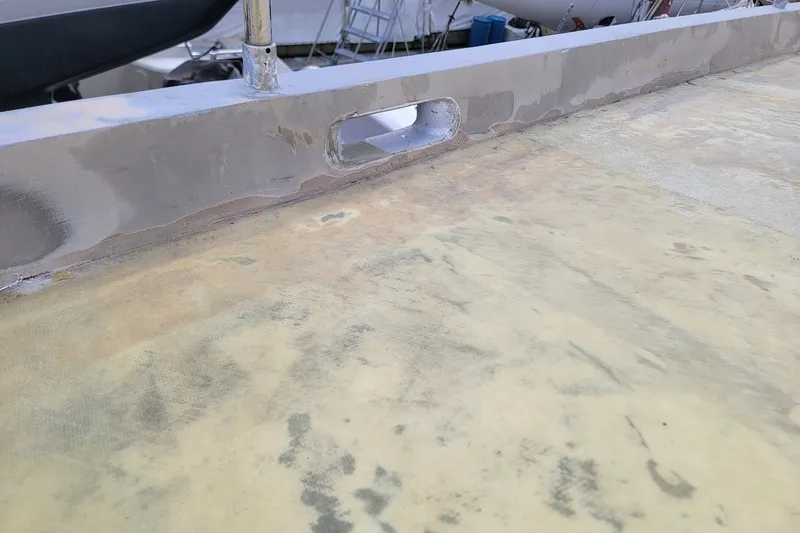 Slide: The Image of Close-up of a 1989 Rob Ladd PH Motorsailer Cutter deck, showing surface details. - 51
