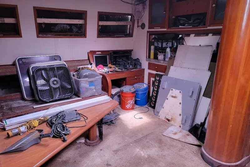 Slide: The Image of Interior of 1989 Custom Rob Ladd PH Motorsailer Cutter, showing tools and equipment in disarray. - 35