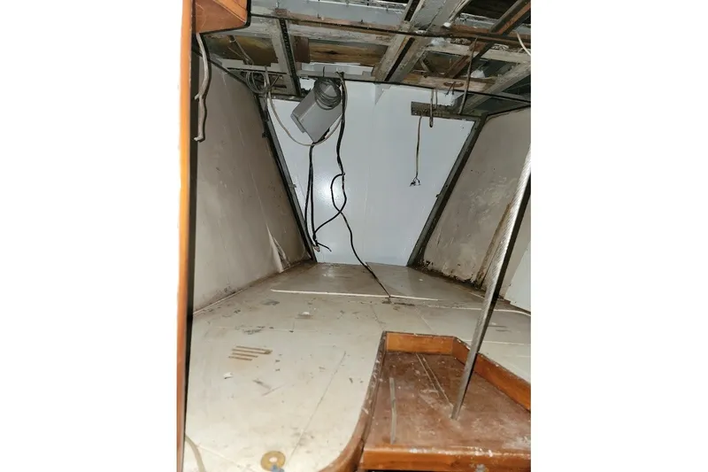 Slide: The Image of Interior of 1989 Custom Rob Ladd PH Motorsailer Cutter, showing unfinished cabin space. - 58