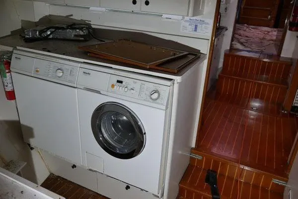 Slide: The Image of Laundry area inside 1989 Custom Robb Ladd Pilothouse Cutter, featuring washer and dryer. - 19