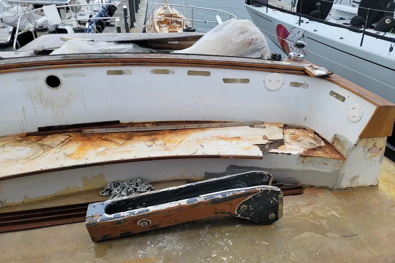 Slide: The Image of Weathered deck of 1989 Custom Rob Ladd PH Motorsailer Cutter, showing rust and damage. - 46