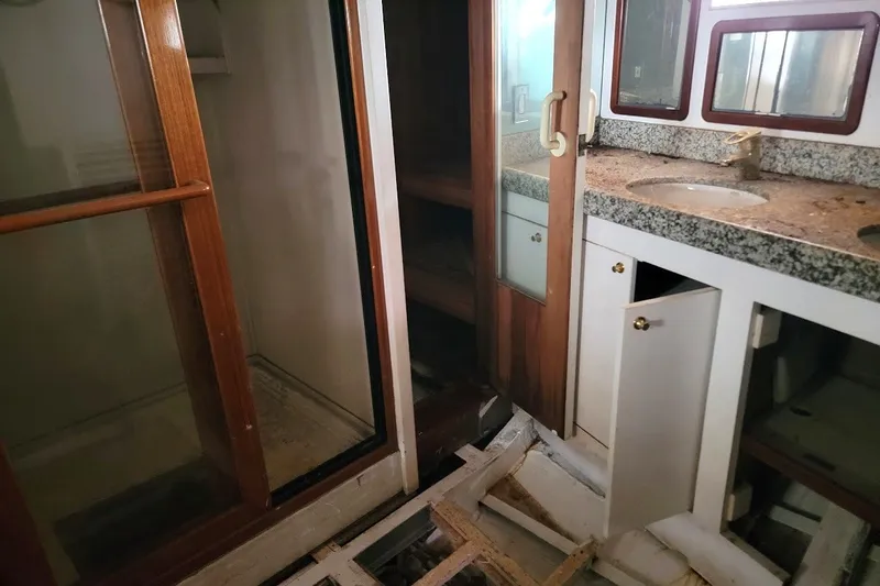 Slide: The Image of Interior of 1989 Rob Ladd PH Motorsailer Cutter, featuring wooden cabinetry and granite countertop. - 40