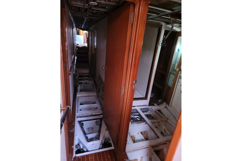 Slide: The Image of Interior view of 1989 Custom Robb Ladd Pilothouse Cutter, showing exposed flooring and wooden doors. - 10