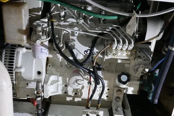 Slide: The Image of Engine compartment of 1989 Custom Robb Ladd Pilothouse Cutter, showcasing intricate mechanical components. - 25