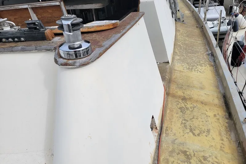 Slide: The Image of Deck view of a 1989 Custom Rob Ladd PH Motorsailer Cutter, showcasing winch and fittings. - 47