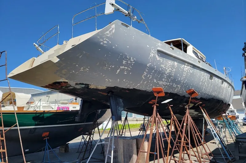 Slide: The Image of Custom Robb Ladd Pilothouse Cutter 98 PH Motorsailer, 1989, under restoration on stands. - 5