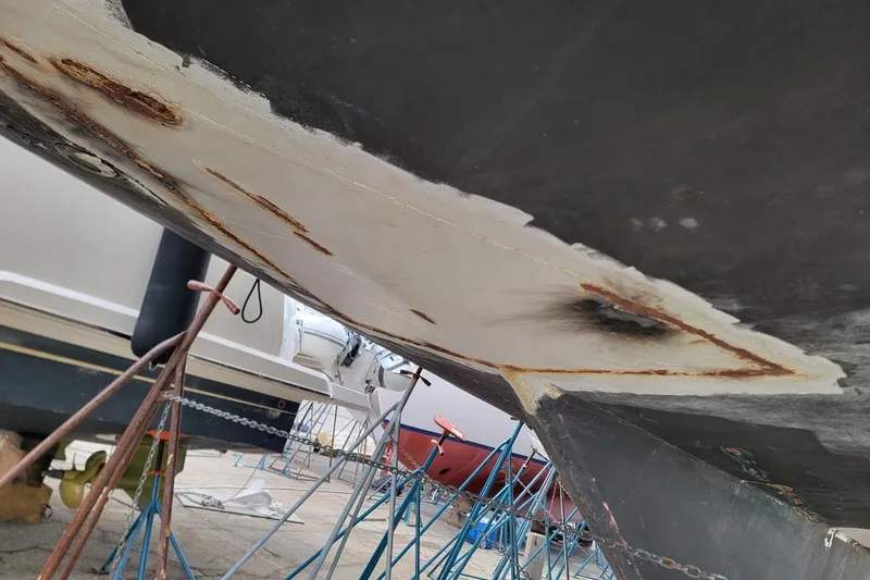 Slide: The Image of Hull repair on 1989 Custom Rob Ladd PH Motorsailer Cutter, supported by stands. - 80