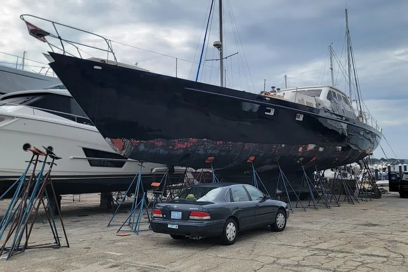 Slide: The Image of Custom 1989 Rob Ladd PH Motorsailer Cutter on stands, with car parked nearby. - 30
