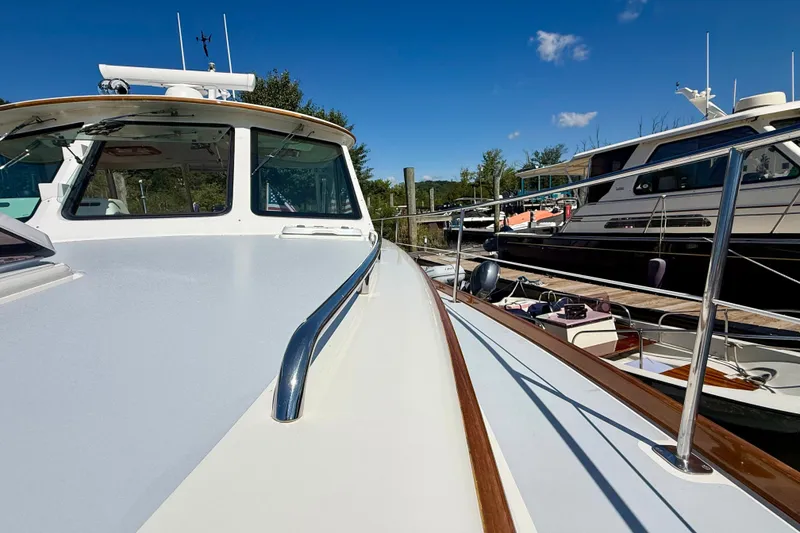 Slide: The Image of Alden 40 Express 1999 yacht docked, showcasing sleek design and polished railings under clear blue sky. - 27