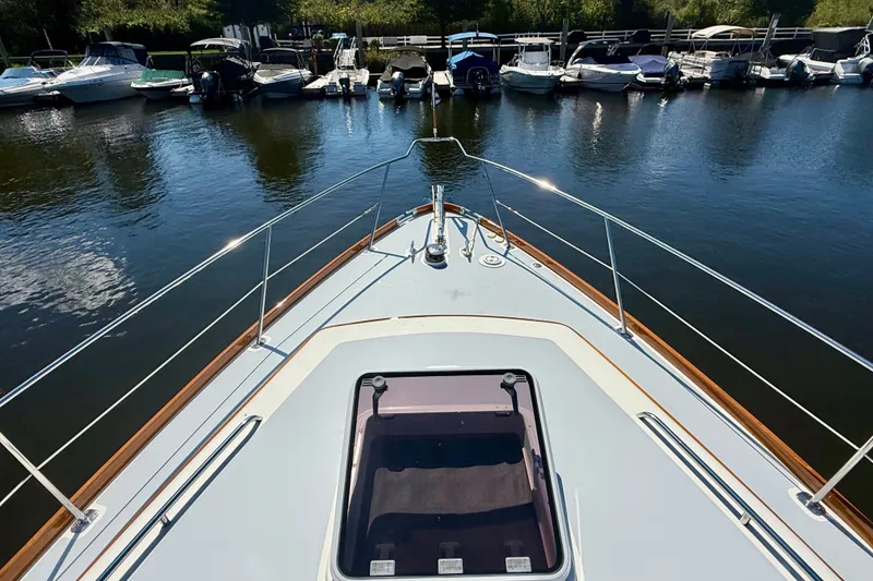 Slide: The Image of Bow view of a 1999 Alden 40 Express yacht docked at a marina. - 19