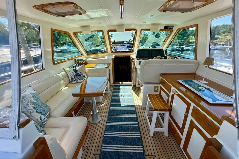 Slide: The Image of Luxurious interior of a 1999 Alden 40 Express yacht with elegant seating and wooden accents. - 33