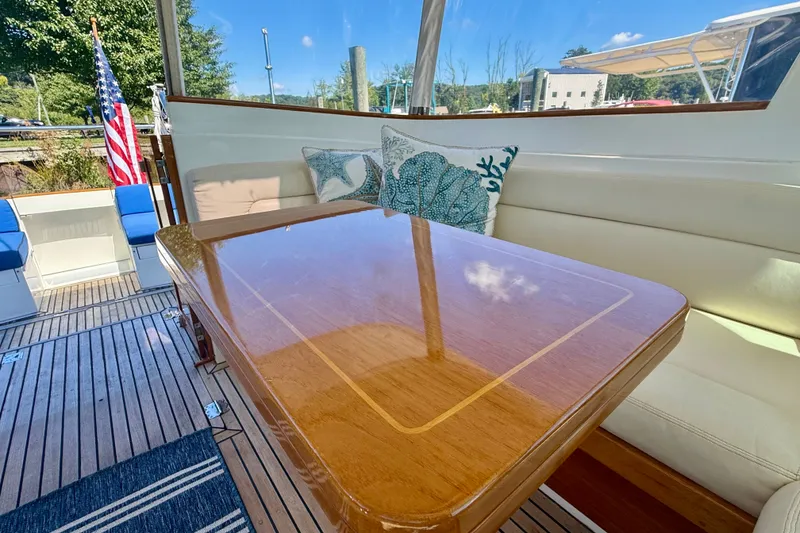 Slide: The Image of Interior of 1999 Alden 40 Express yacht with polished wood table and nautical decor. - 34