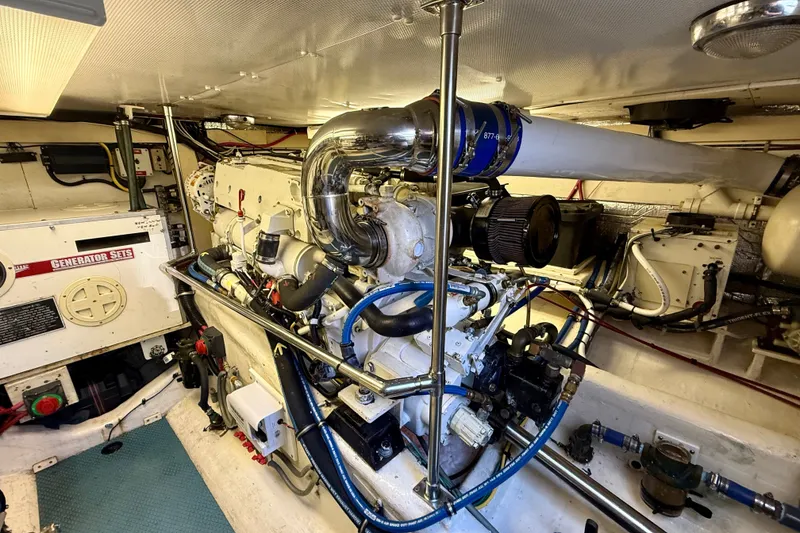 Slide: The Image of Engine room of a 1999 Alden 40 Express yacht, featuring generator and mechanical components. - 53