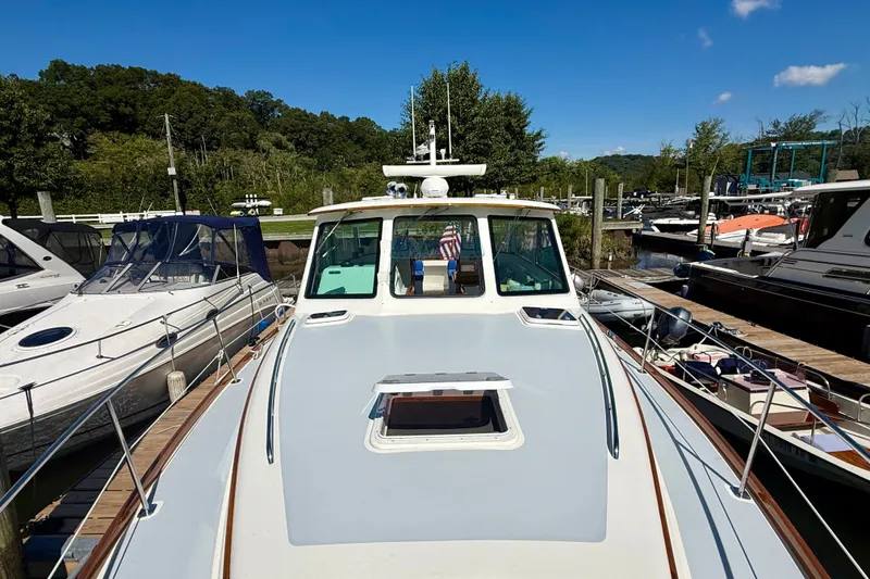 Slide: The Image of Alden 40 Express 1999 yacht docked at a marina under clear blue skies. - 23