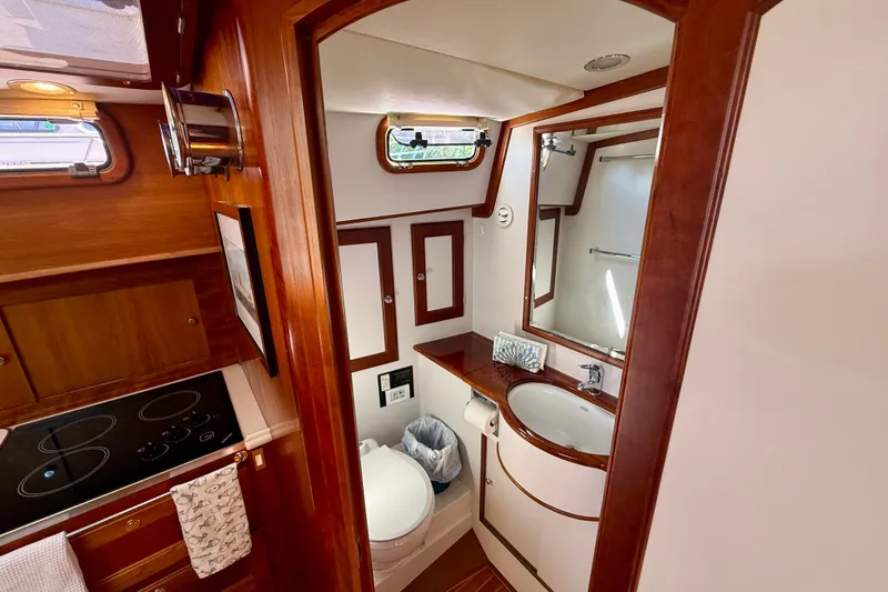 Slide: The Image of Luxurious 1999 Alden 40 Express yacht bathroom with wooden cabinetry and modern fixtures. - 43