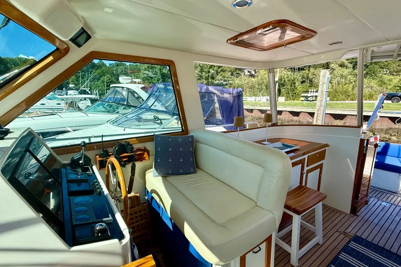 Slide: The Image of Interior of 1999 Alden 40 Express yacht with helm, seating, and wooden accents. - 31