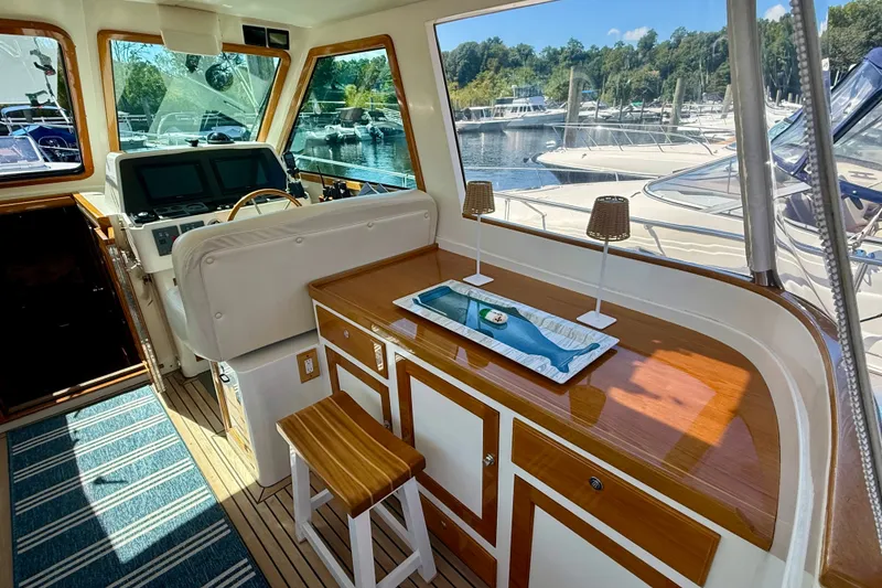 Slide: The Image of Interior of 1999 Alden 40 Express yacht with helm, seating, and wooden cabinetry. - 29