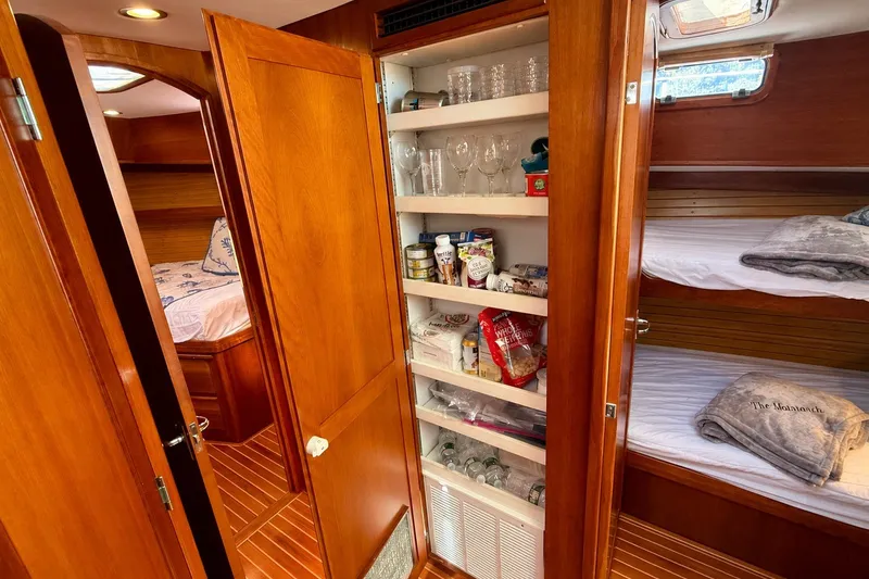 Slide: The Image of Interior of 1999 Alden 40 Express yacht with wooden cabinetry and cozy sleeping quarters. - 41