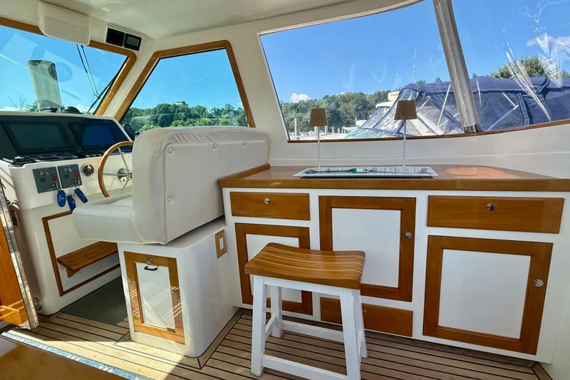 Slide: The Image of Interior of a 1999 Alden 40 Express yacht with helm and wooden cabinetry. - 35