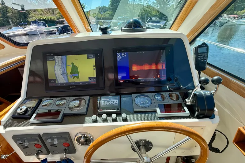 Slide: The Image of Cockpit of 1999 Alden 40 Express with navigation screens and controls. - 37