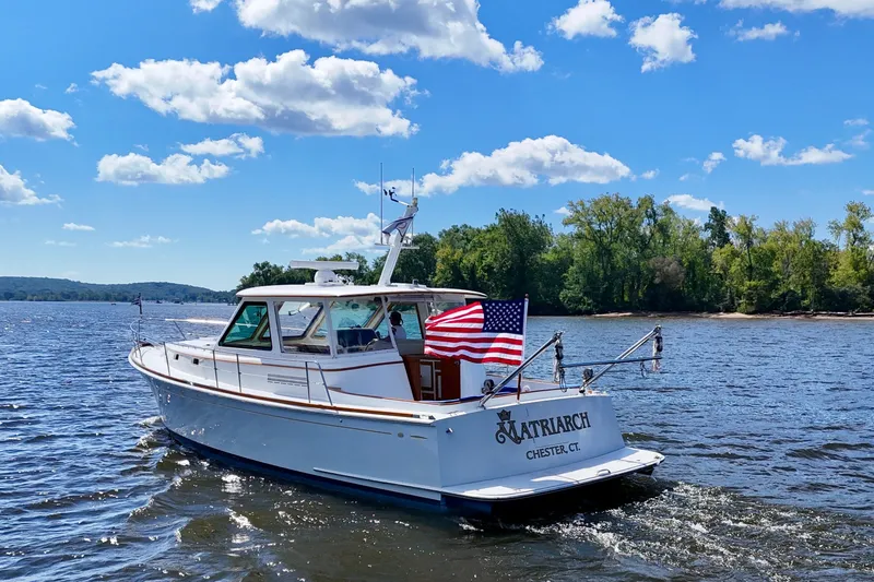 Slide: The Image of Alden 40 Express 1999 boat cruising on a sunny day with American flag. - 5