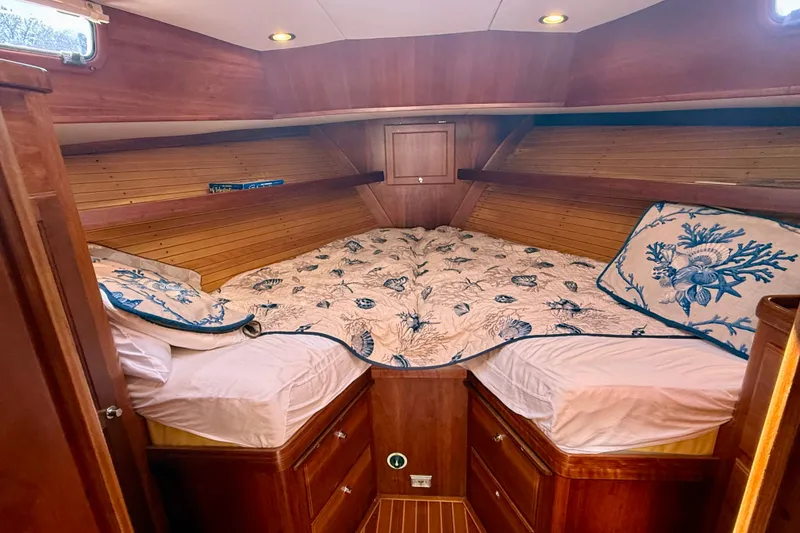 Slide: The Image of Cozy cabin interior of 1999 Alden 40 Express yacht with nautical-themed bedding. - 46