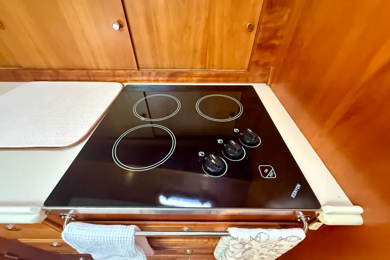 Slide: The Image of Modern induction cooktop in 1999 Alden 40 Express yacht kitchen. - 50
