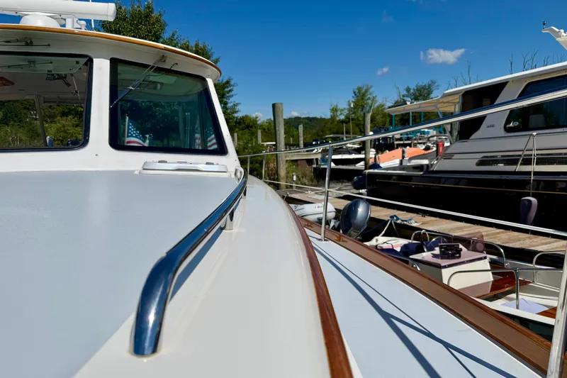 Slide: The Image of 1999 Alden 40 Express yacht docked, showcasing sleek design and polished railings. - 26