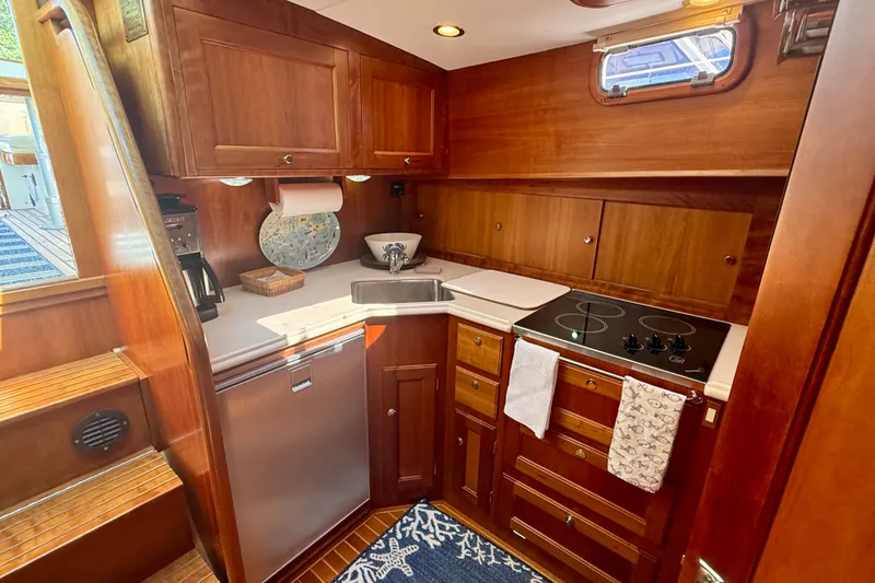 Slide: The Image of Luxurious 1999 Alden 40 Express yacht kitchen with wood cabinetry and modern appliances. - 39