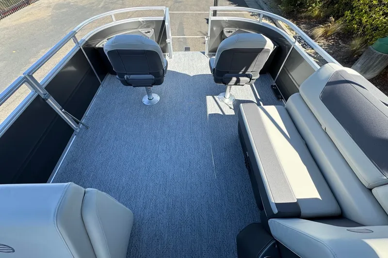Slide: The Image of 2026 Sun Tracker Fishin' Barge 22 DLX interior with seating and helm. - 14