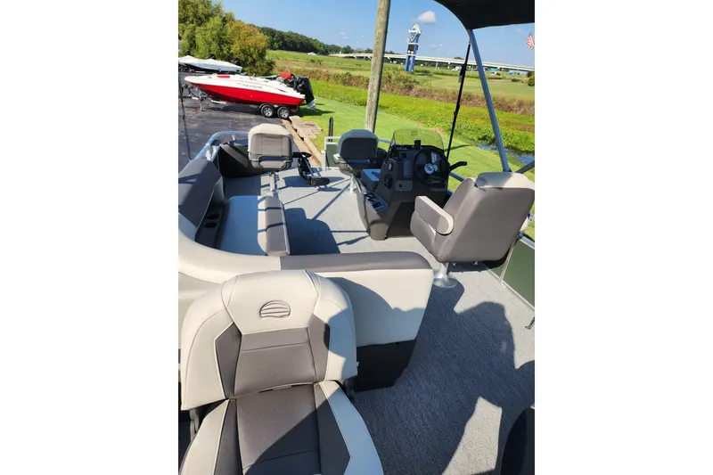 Slide: The Image of 2027 Sun Tracker Bass Buggy 18 DLX pontoon boat interior with seating and helm. - 17