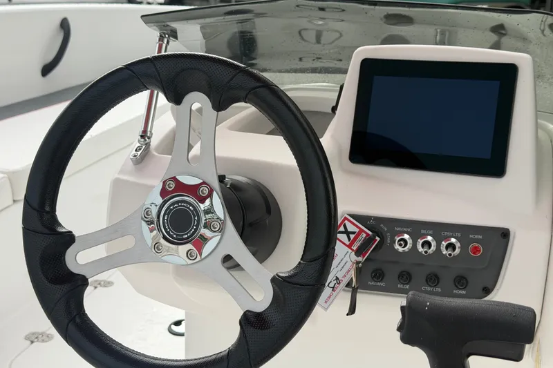 Slide: The Image of Steering wheel and dashboard of 2027 Tahoe T18 boat with touchscreen display. - 9