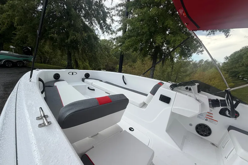 Slide: The Image of 2027 Tahoe T18 boat interior with white seating and red accents, parked outdoors. - 6