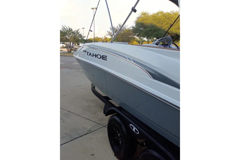 Slide: The Image of 2027 Tahoe 1950 boat on trailer, parked outdoors. - 3