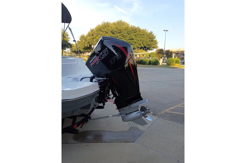 Slide: The Image of Outboard motor on a 2027 Tahoe 1950 boat, parked outdoors. - 4