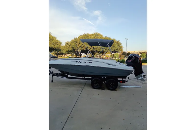 Slide: The Image of 2027 Tahoe 1950 boat with canopy and outboard motor on trailer. - 9
